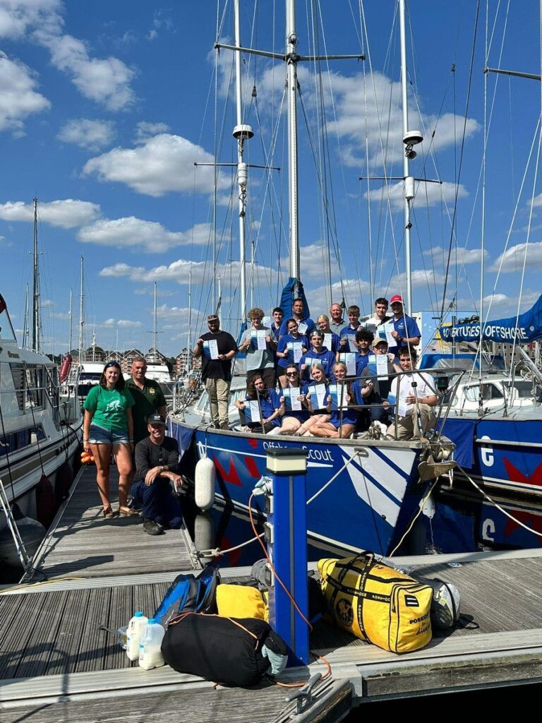 The crew celebrating with their Competent Crew certificates at journey's end
