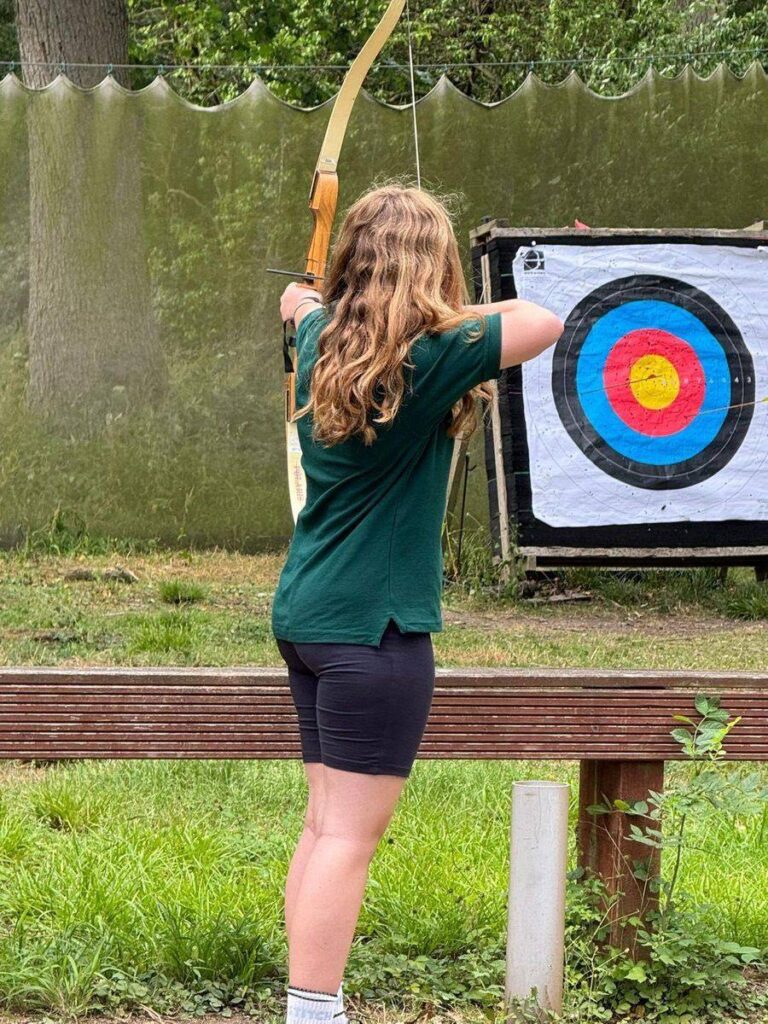A young person taking aim during the soft archery session