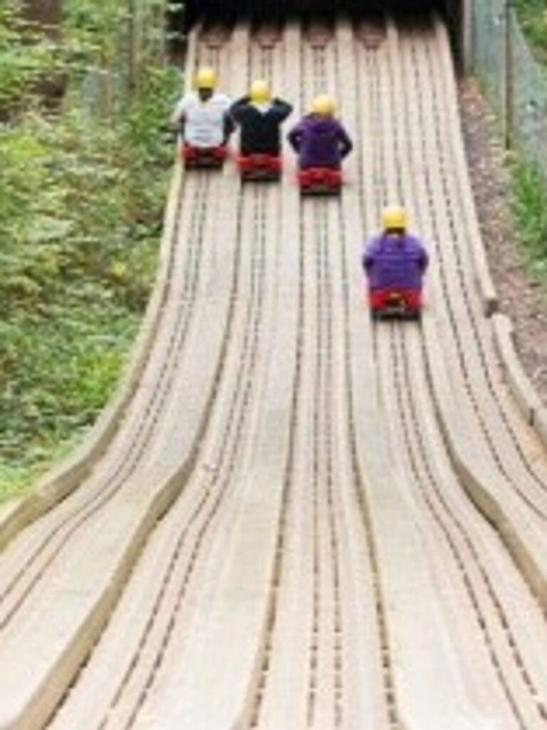 Barton Scouts racing down a toboggan run at camp