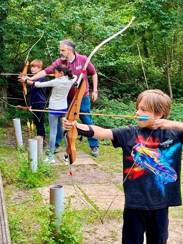 Harlington Scouts trying archery in the woods
