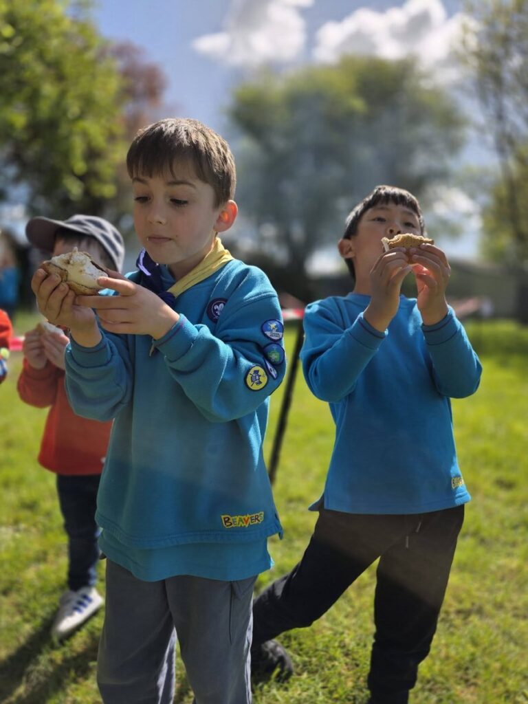 St Anne's Beavers toasting marshmallows over a campfire