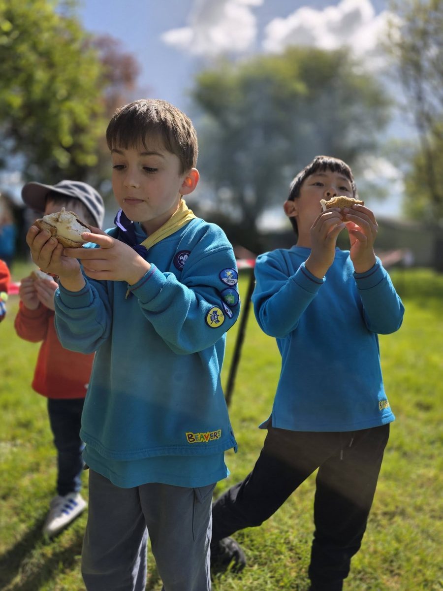 St Anne's Beavers toasting marshmallows over a campfire