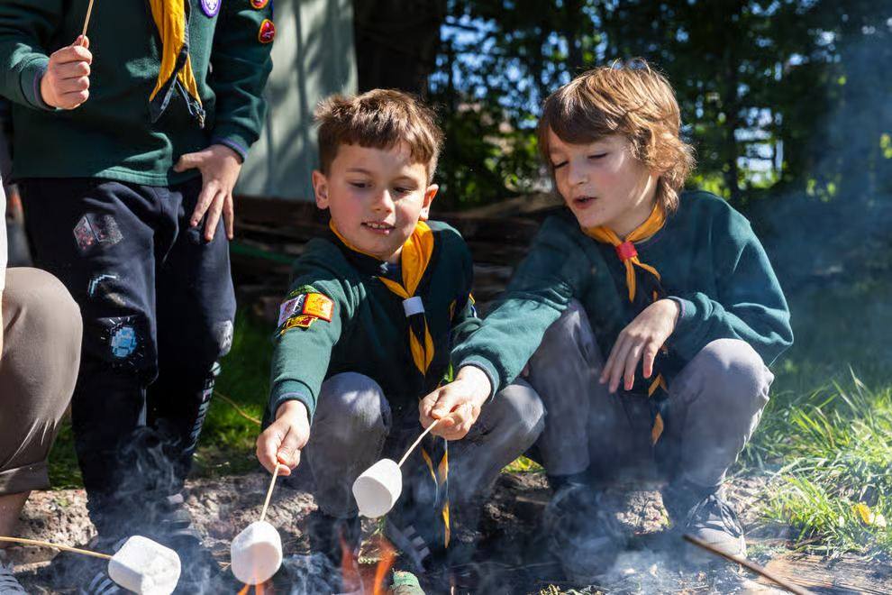 Beavers toasting marshmallows over the fire pit at Ross Park